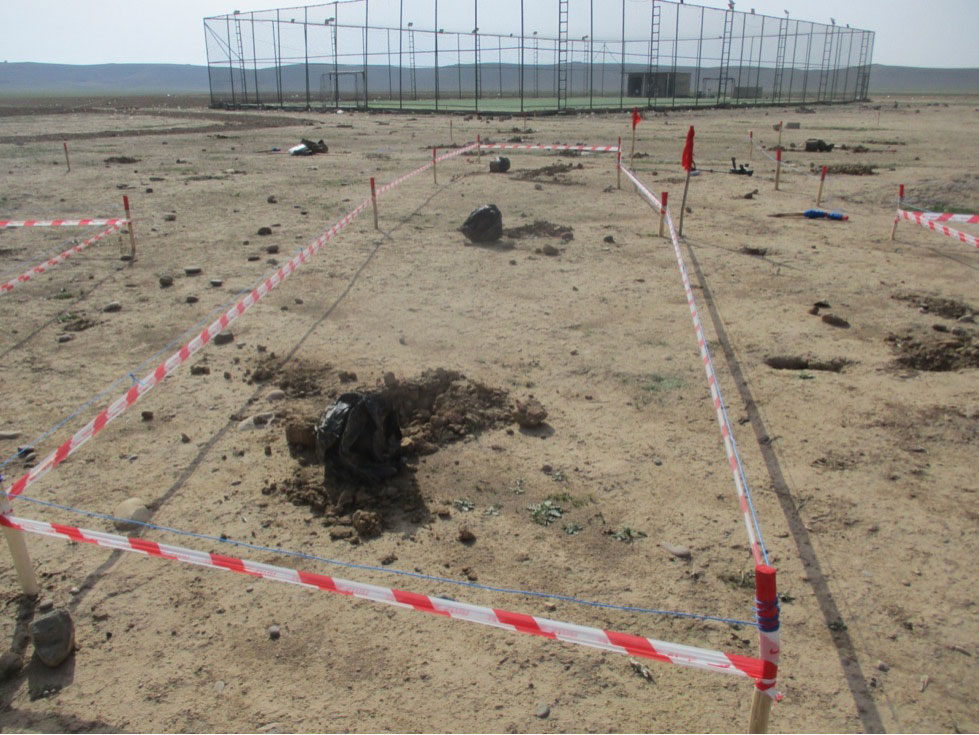 Several improvised mines partially excavated near the football field in Sultan Abdullah village (March 2022)