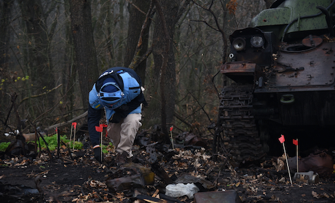 Deminer flagging potential ordnance sites in Ukraine