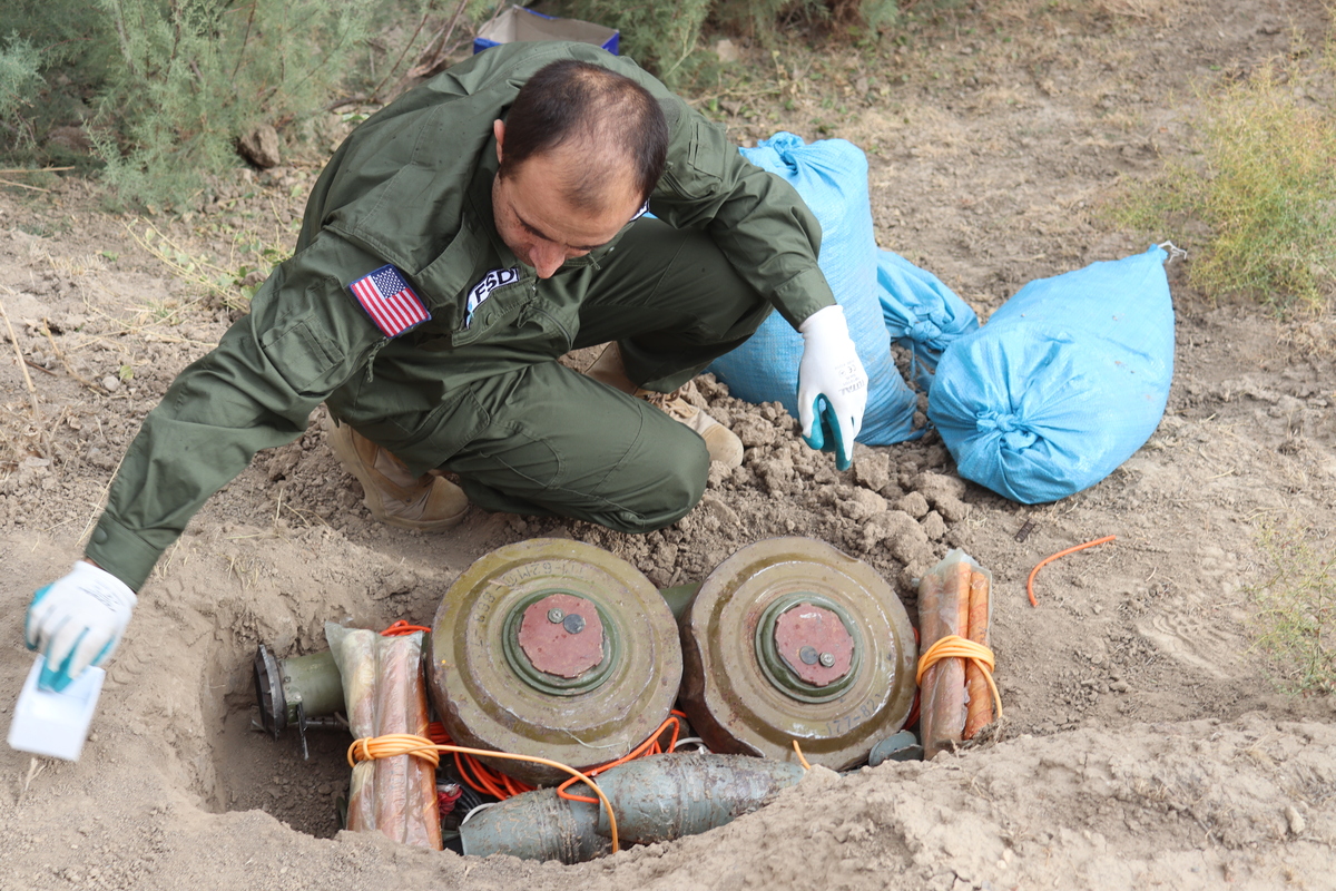 A deminer preparing to destroy an explosive ordnance stockpile in Tajikistan.