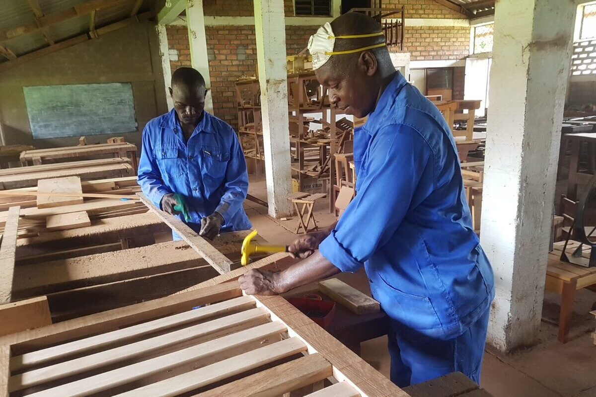 Two men doing carpentry in a workshop