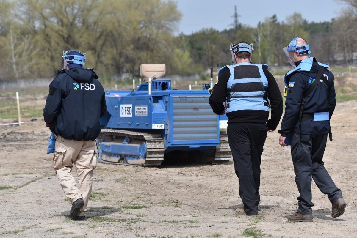 Three Ukrainian men with a machine specialized in mine clearance