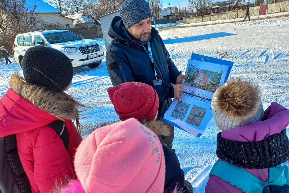 FSD employee giving explosive ordnance risk education to children in the village of Noviy Bilous Ukraine