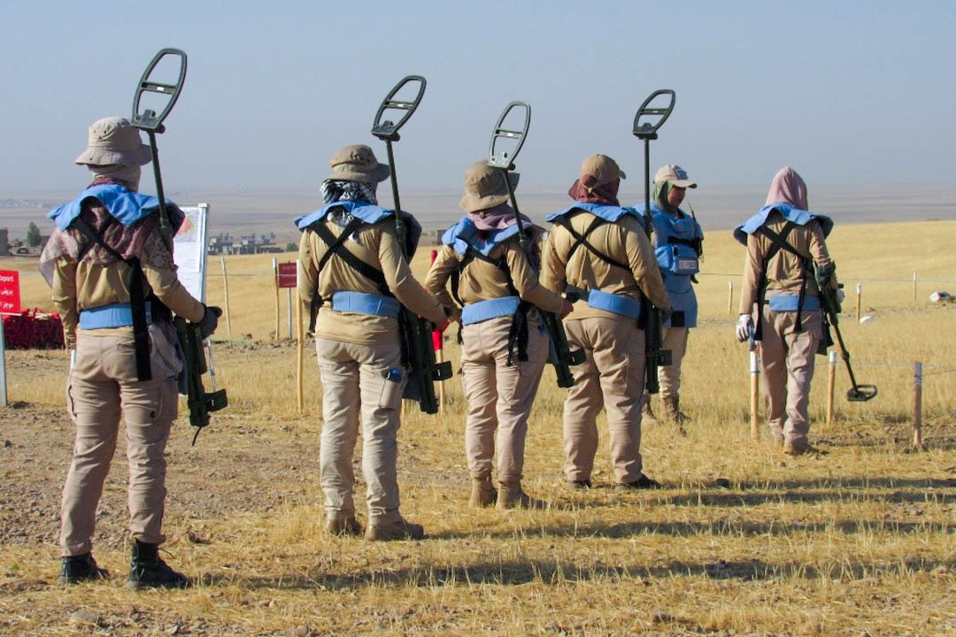 Clearance deminers preparing to conduct metal detector testing procedures in Bashiqa, Iraq