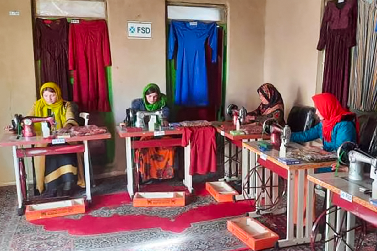 Women in Afghanistan sewing clothes for the local market.