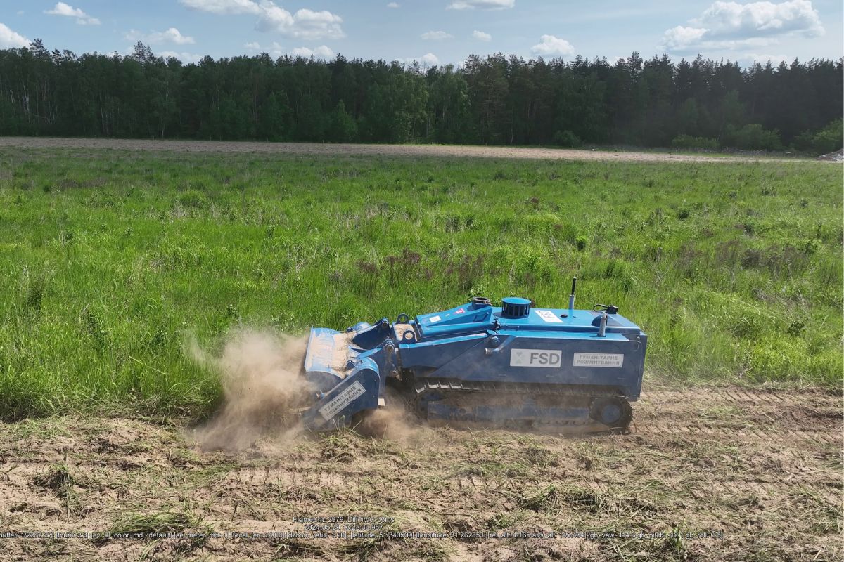picture machine in Ukraine - Our history 2024 card FSD deminers taking a practical demining exam before being deployed to the minefield.